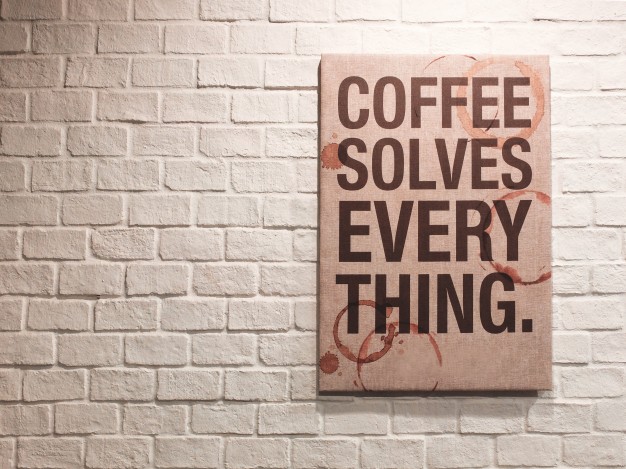 inspirational-motivating-quote-about-coffee-on-canvas-frame-hanging-on-brick-wall-in-the-cafe_1356-43